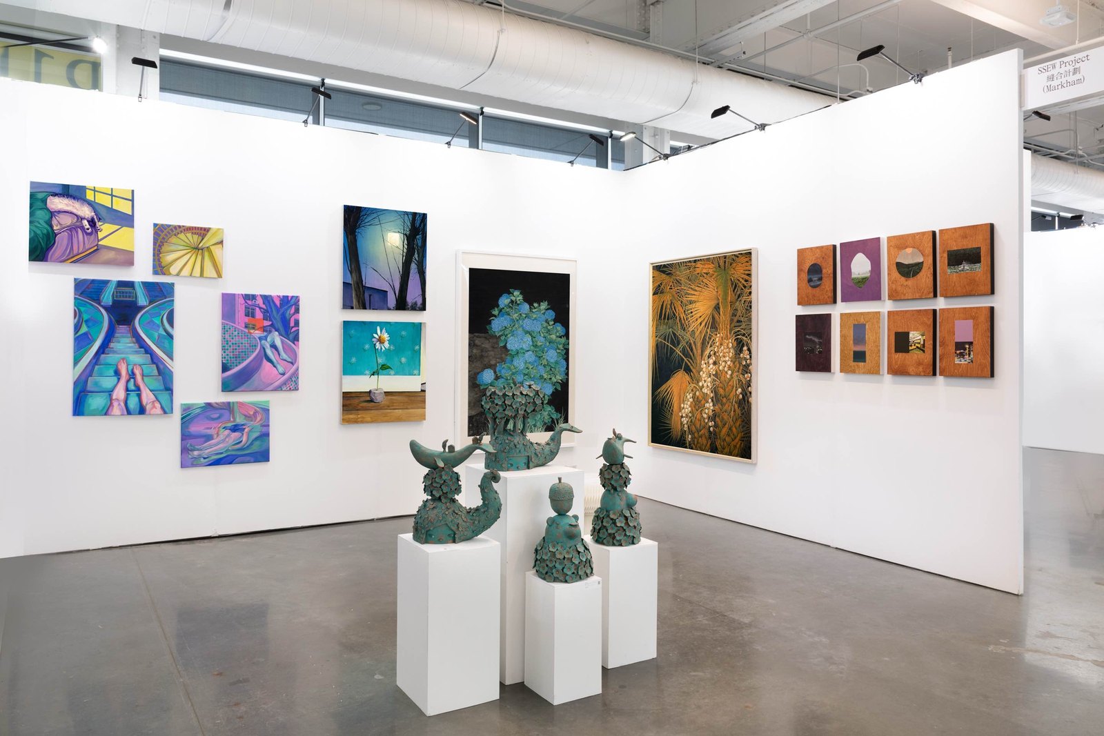 SSEW Project booth at Plural 2026, Montreal — bronze sculptures on white plinths